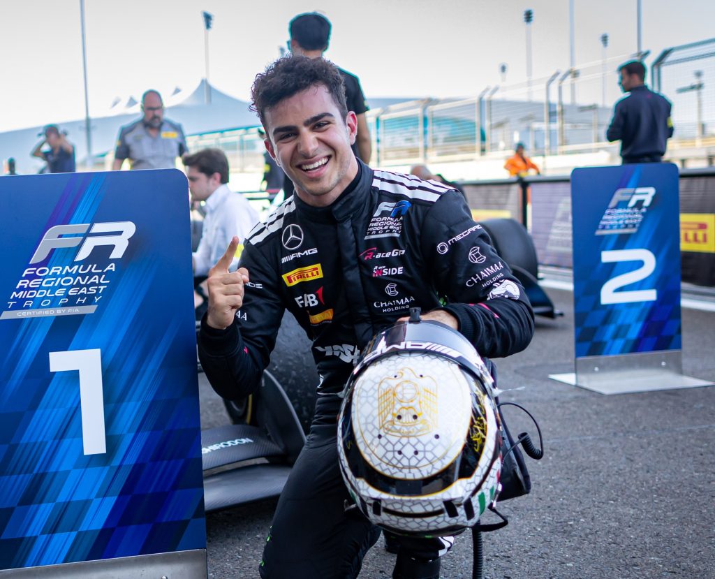 R-ace GP driver in a MegaRide-branded race suit